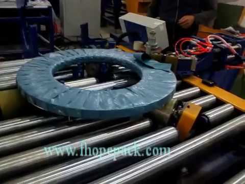 Coil wrapping machine with tapping and barcode printer