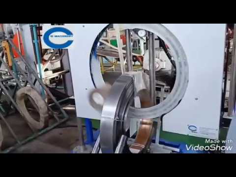 Vertical steel coil wrapping machine with motorized ting up down system